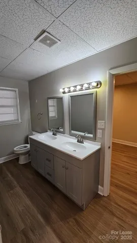 a bathroom with a double vanity sink and mirror