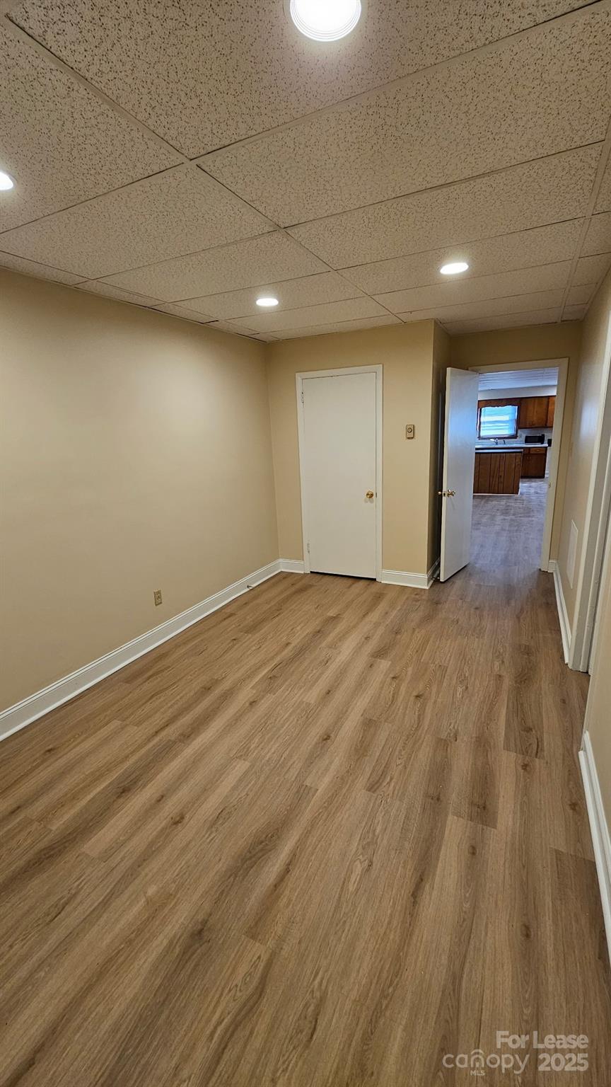 321 Connelly Springs Road, Unit A Lenoir, NC 28645 - Photo 10 of 12 an empty room with wooden floor and windows