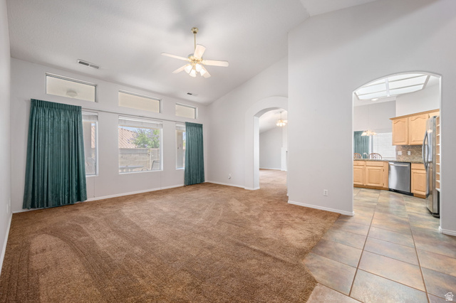 39 North Valley View Drive, Unit 51 St. George, UT 84770 - Photo 4 of 25 Vaulted ceiling living area with a ceiling fan, multiple windows, and transom windows