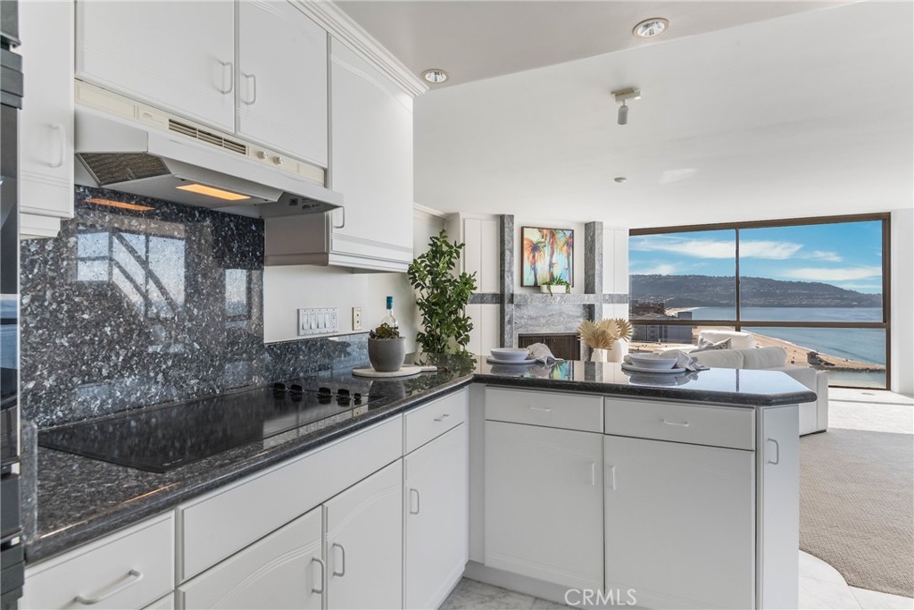531 Esplanade, Unit 916 Redondo Beach, CA 90277 - Photo 12 of 41 a kitchen with stainless steel appliances granite countertop a sink and cabinets