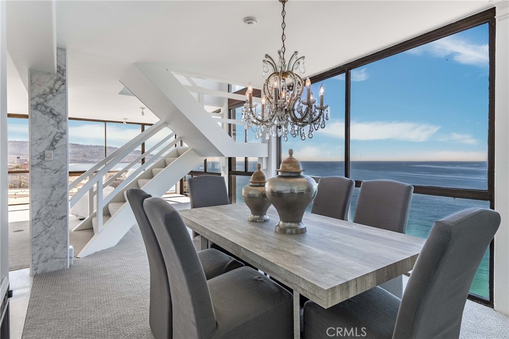 531 Esplanade, Unit 916 Redondo Beach, CA 90277 - Photo 15 of 41 a view of a dining room with furniture a chandelier and wooden floor