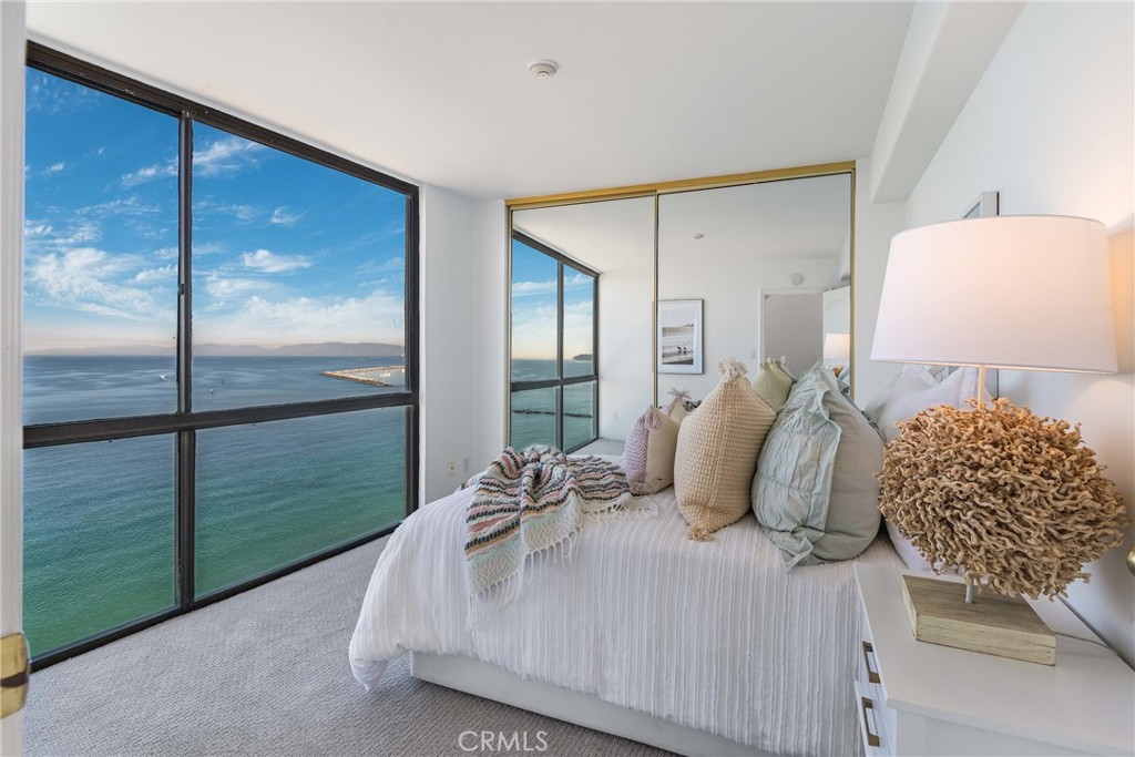 531 Esplanade, Unit 916 Redondo Beach, CA 90277 - Photo 16 of 41 a bedroom with a bed and window