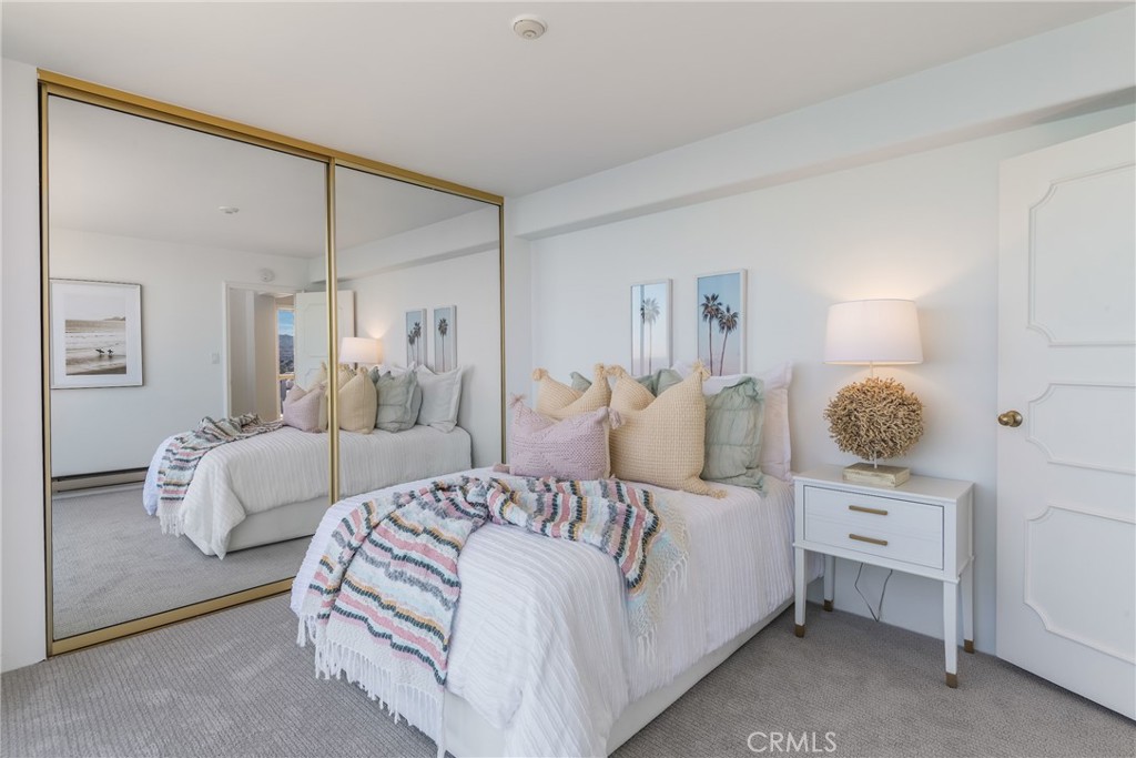 531 Esplanade, Unit 916 Redondo Beach, CA 90277 - Photo 17 of 41 a bedroom with a bed and a night stand