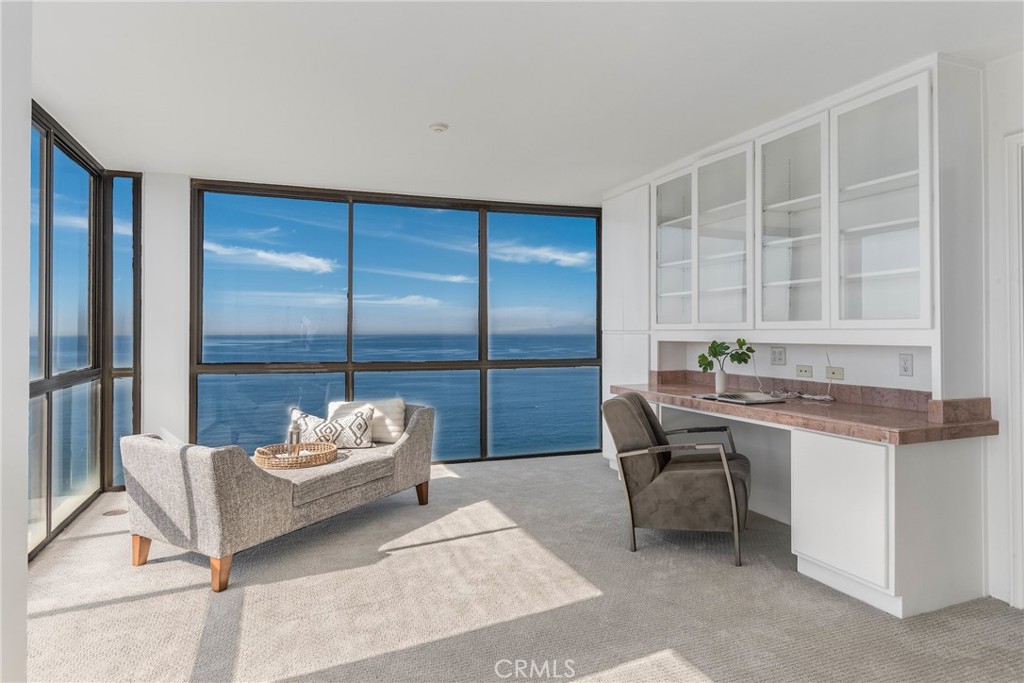 531 Esplanade, Unit 916 Redondo Beach, CA 90277 - Photo 21 of 41 a living room with granite countertop furniture and a floor to ceiling window