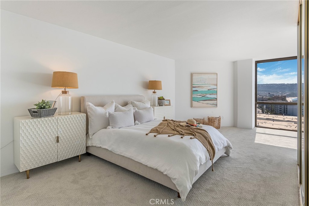531 Esplanade, Unit 916 Redondo Beach, CA 90277 - Photo 23 of 41 a bedroom with a bed and a window