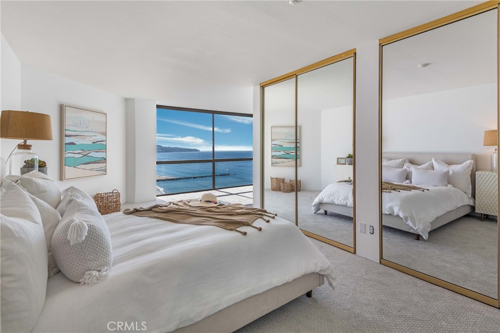 531 Esplanade, Unit 916 Redondo Beach, CA 90277 - Photo 24 of 41 a bedroom with a bed and large window
