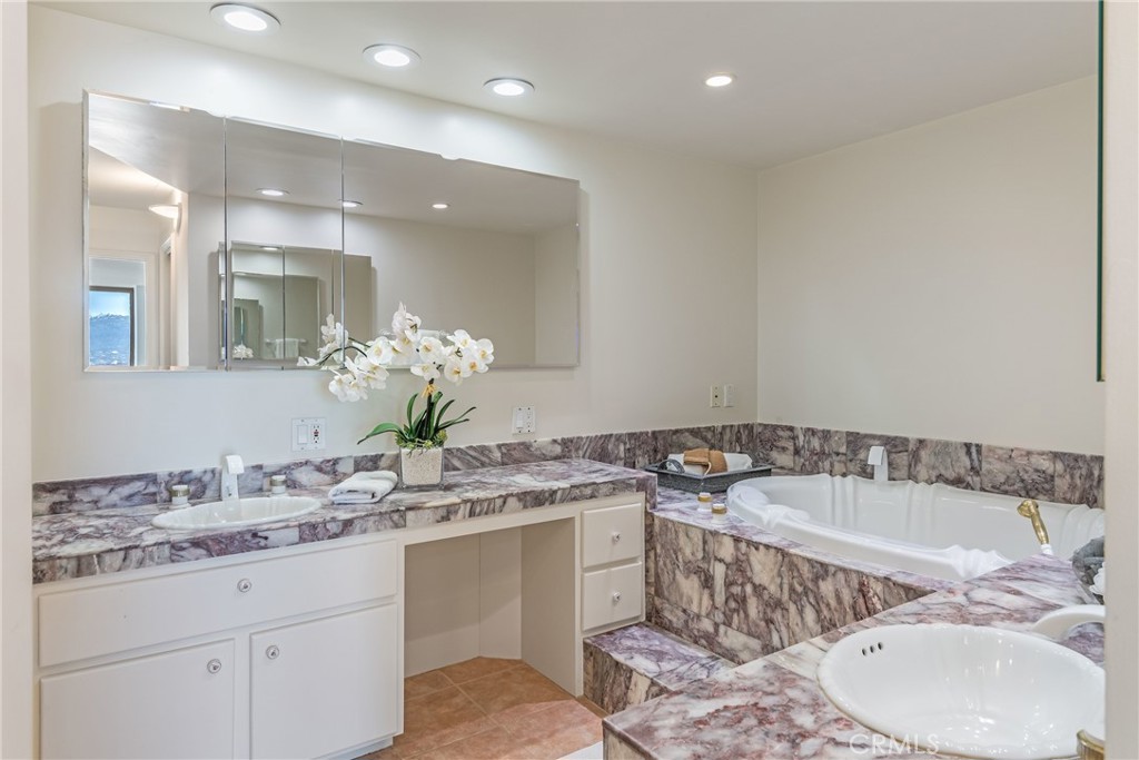 531 Esplanade, Unit 916 Redondo Beach, CA 90277 - Photo 25 of 41 a bath room with a sink and a mirror