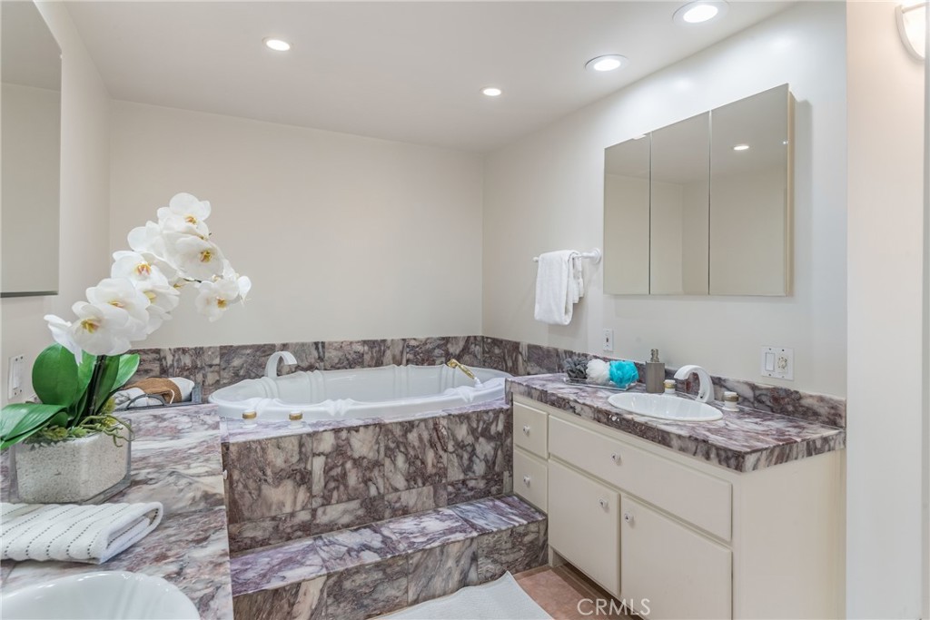 531 Esplanade, Unit 916 Redondo Beach, CA 90277 - Photo 26 of 41 a bathroom with a granite countertop sink and a mirror