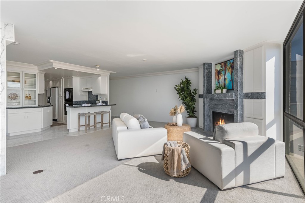 531 Esplanade, Unit 916 Redondo Beach, CA 90277 - Photo 7 of 41 a living room with furniture and a kitchen view