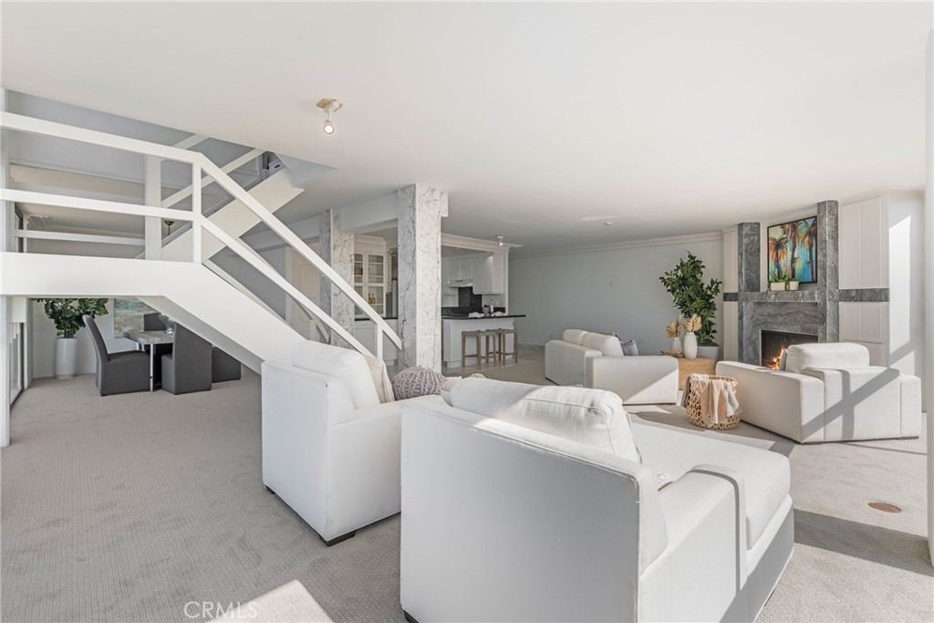531 Esplanade, Unit 916 Redondo Beach, CA 90277 - Photo 8 of 41 a living room with furniture and a chandelier