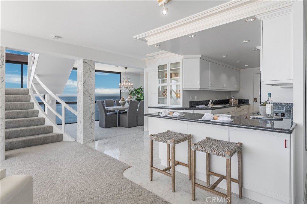 531 Esplanade, Unit 916 Redondo Beach, CA 90277 - Photo 9 of 41 a kitchen with granite countertop a sink and cabinets