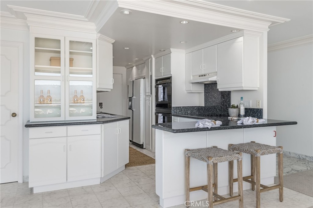 531 Esplanade, Unit 916 Redondo Beach, CA 90277 - Photo 10 of 41 a kitchen with stainless steel appliances granite countertop a sink and cabinets