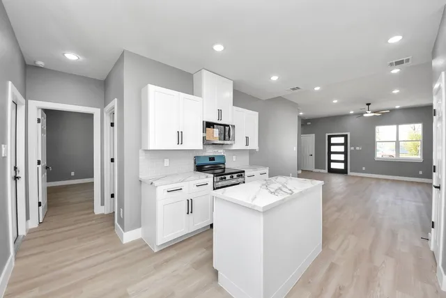 a kitchen with a sink stove and refrigerator