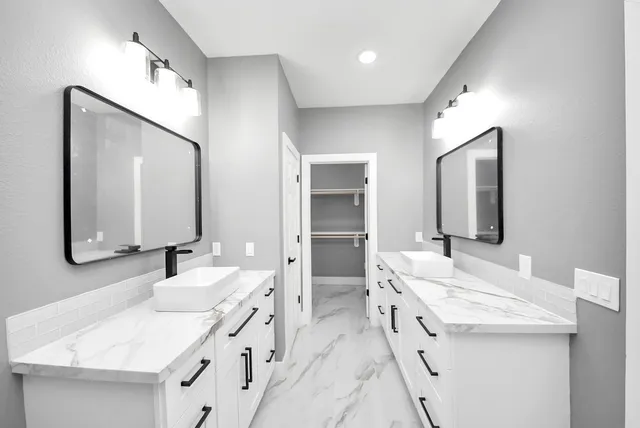 a bathroom with a double vanity sink and mirror