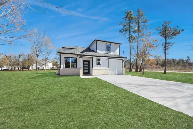 a front view of a house with a garden