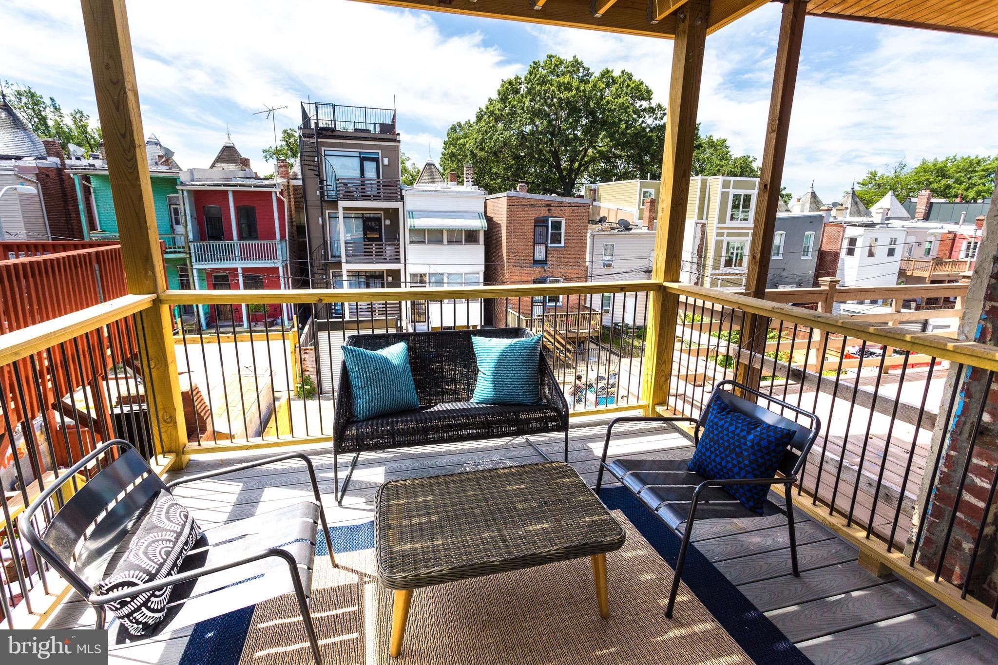53 R Street Northeast, Unit 2 Washington, DC 20002 - Photo 11 of 25 a view of a balcony with two chairs and a potted plant