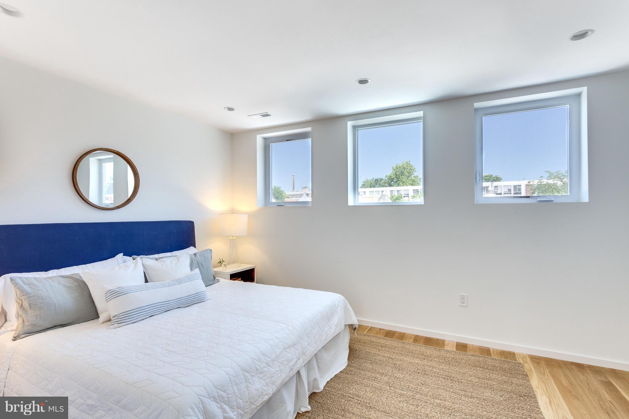 53 R Street Northeast, Unit 2 Washington, DC 20002 - Photo 15 of 25 a bedroom with a large bed and wooden floor