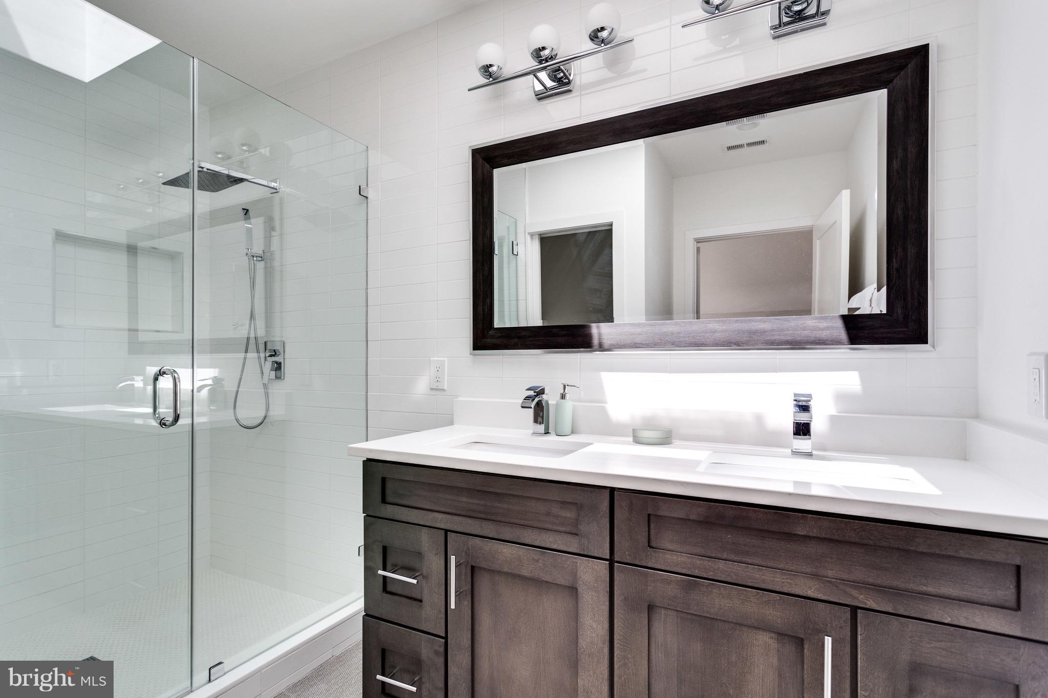 53 R Street Northeast, Unit 2 Washington, DC 20002 - Photo 16 of 25 a bathroom with a double vanity sink mirror and