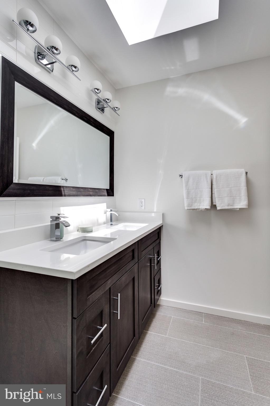 53 R Street Northeast, Unit 2 Washington, DC 20002 - Photo 17 of 25 a bathroom with a sink and a mirror