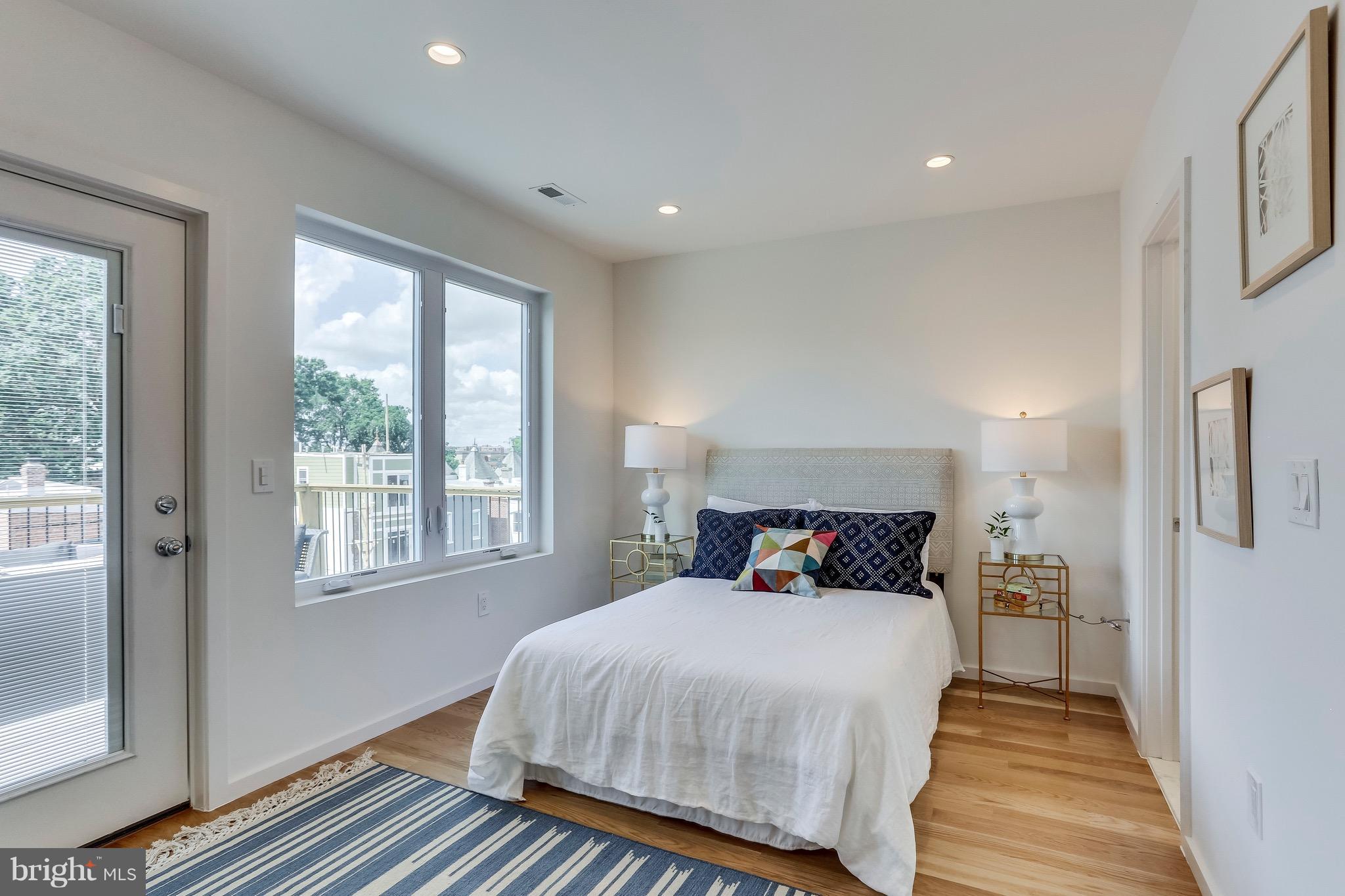 53 R Street Northeast, Unit 2 Washington, DC 20002 - Photo 18 of 25 a bedroom with a bed and wooden floor