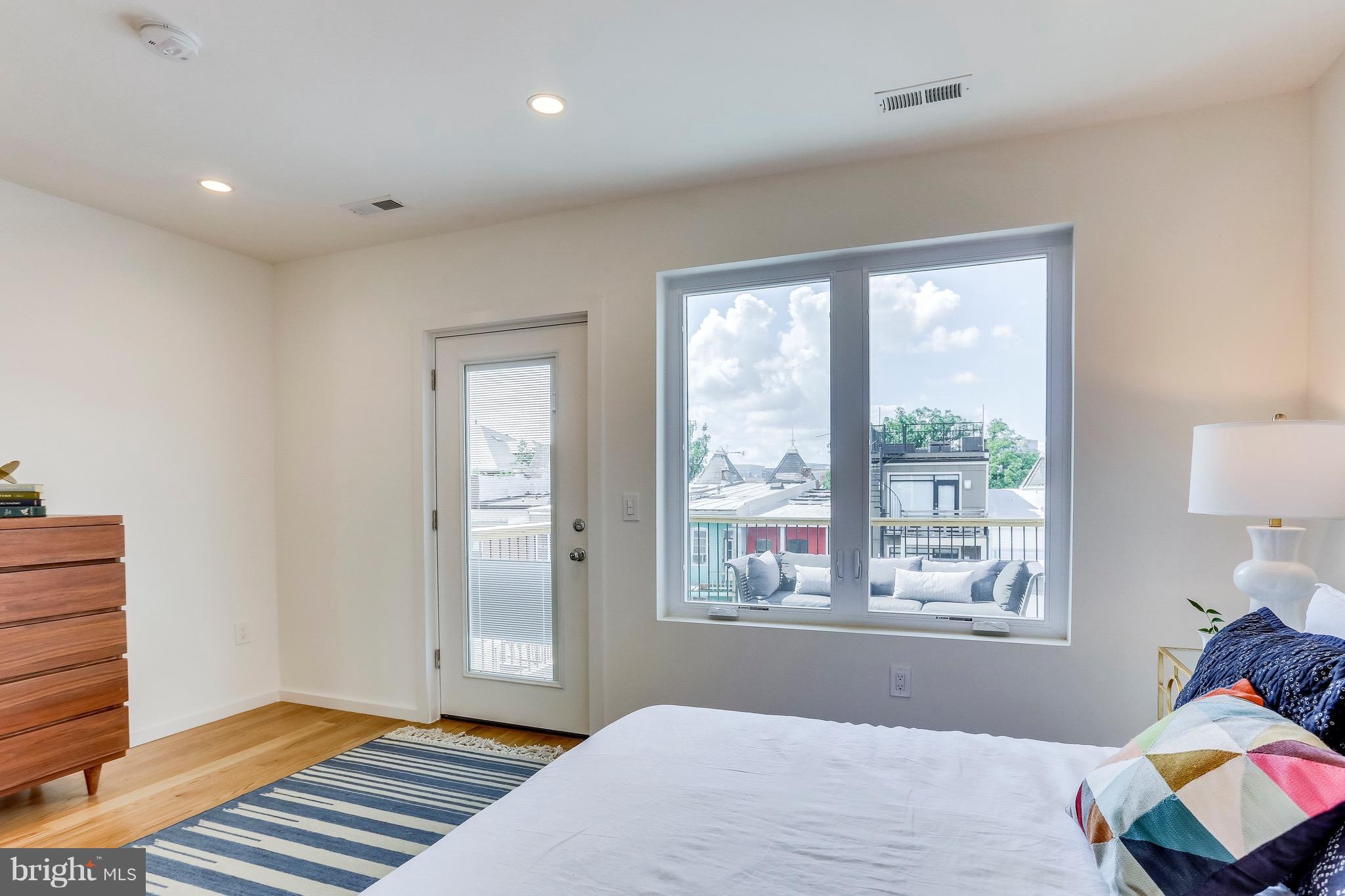 53 R Street Northeast, Unit 2 Washington, DC 20002 - Photo 19 of 25 a bedroom with bed and wooden floor