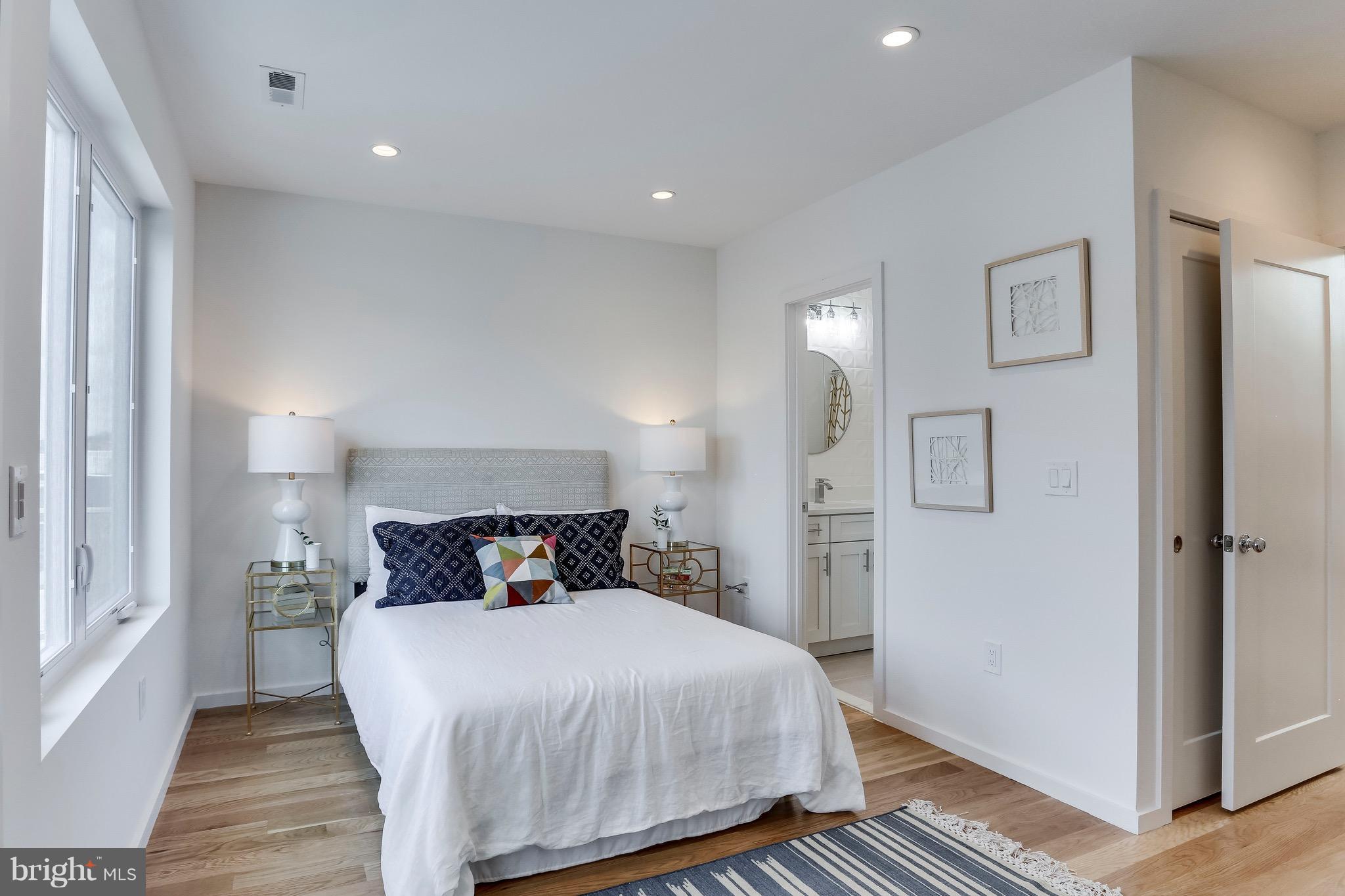 53 R Street Northeast, Unit 2 Washington, DC 20002 - Photo 20 of 25 a bedroom with a bed and wooden floor