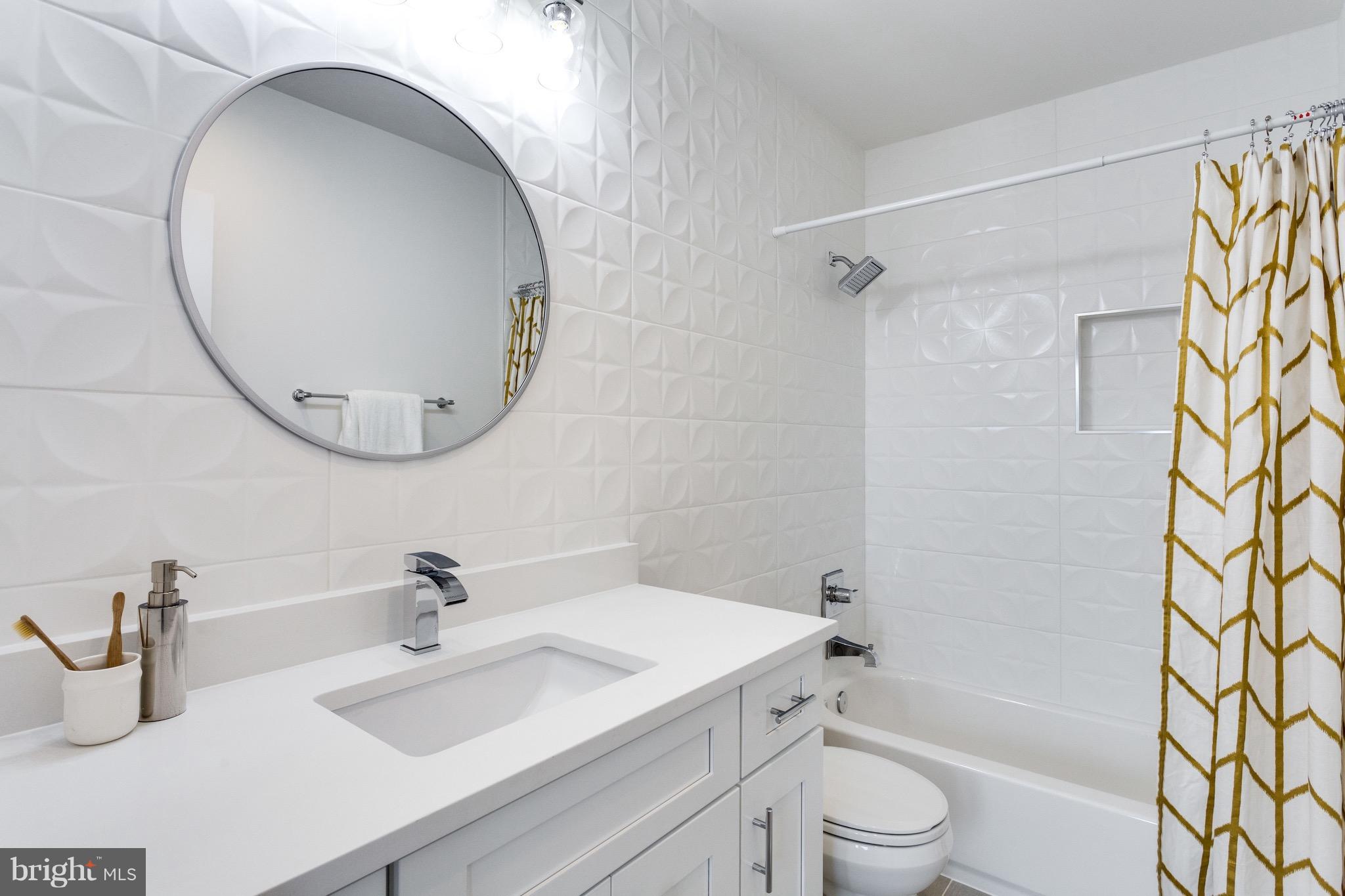 53 R Street Northeast, Unit 2 Washington, DC 20002 - Photo 21 of 25 a bathroom with a sink a toilet and a mirror