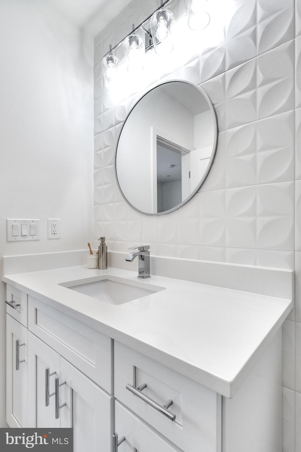 53 R Street Northeast, Unit 2 Washington, DC 20002 - Photo 22 of 25 a bathroom with a sink and a mirror