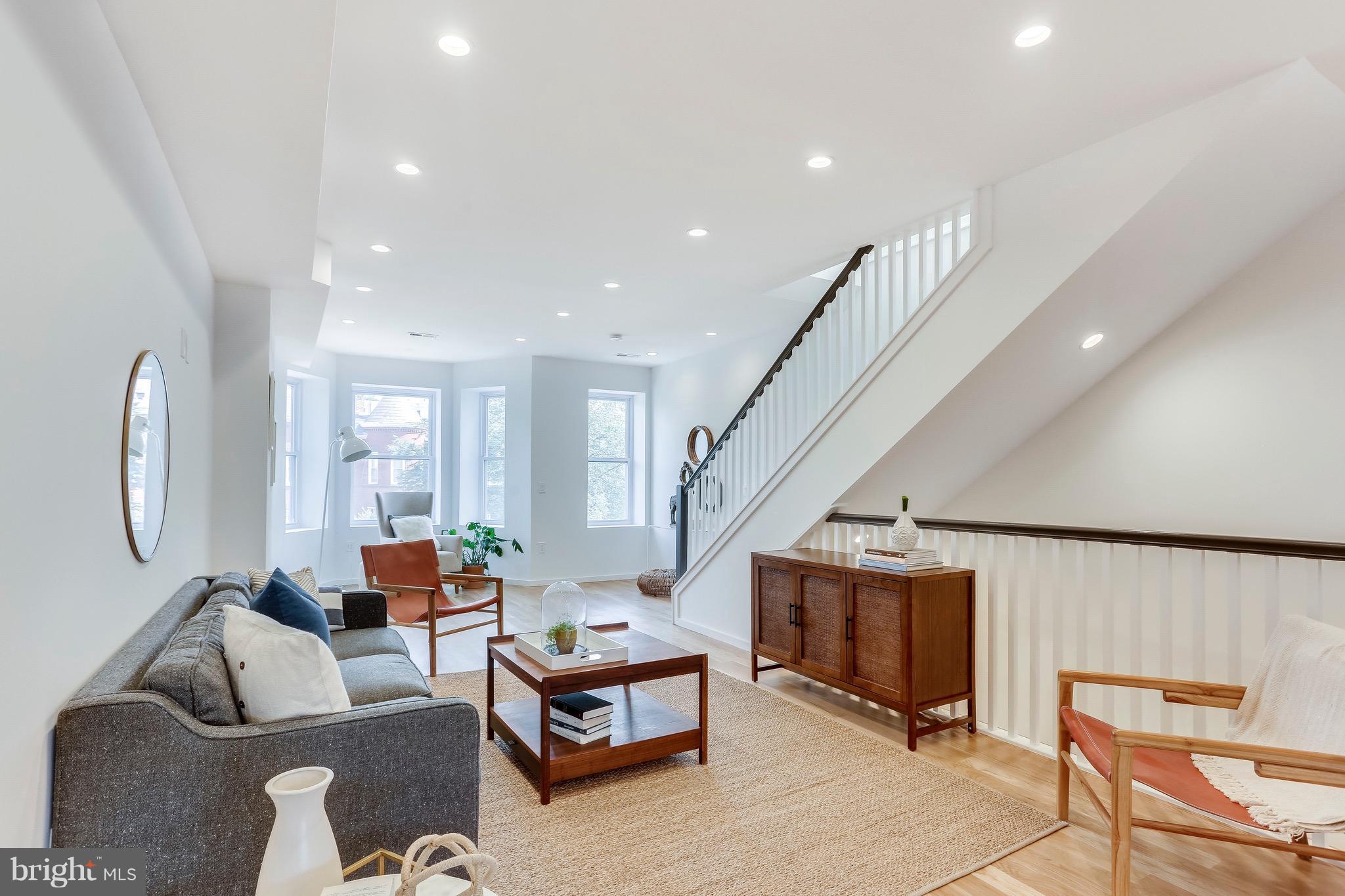 53 R Street Northeast, Unit 2 Washington, DC 20002 - Photo 7 of 25 a living room with furniture a air conditioner vent and a window