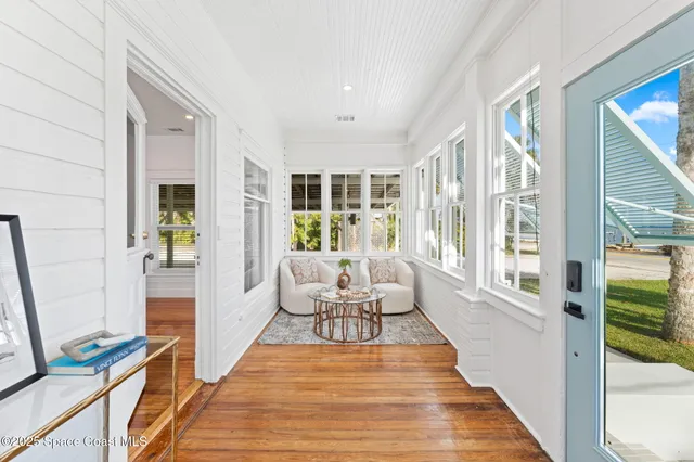 a living room with furniture and wooden floor