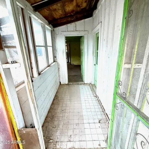 a view of a hallway with wooden floor and stairs