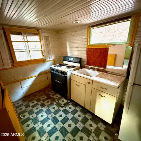 a kitchen with a stove next to a window