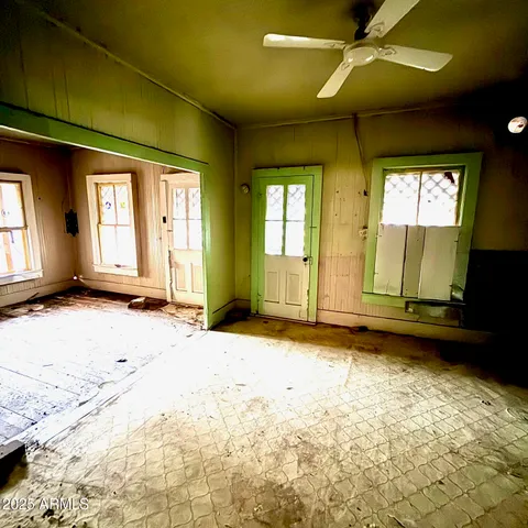 a view of a livingroom with wooden floor and a window