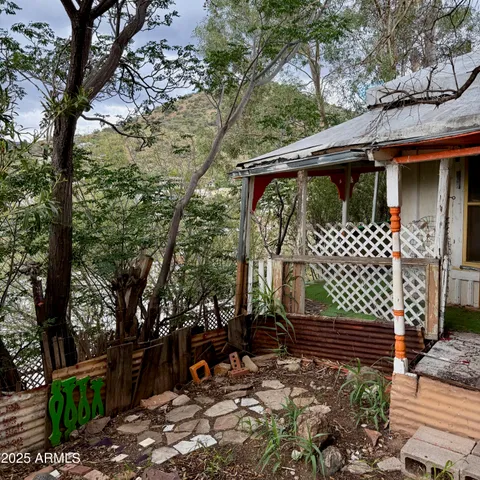a view of a wooden house with a large tree