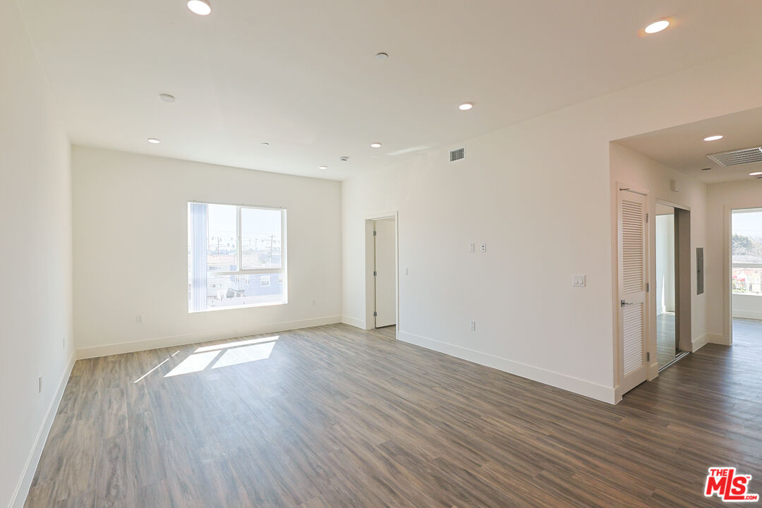 4000 Mont Clair Street, Unit 201 Los Angeles, CA 90018 - Photo 16 of 21 an empty room with wooden floor and windows