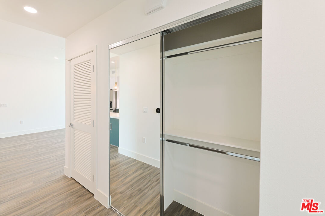 4000 Mont Clair Street, Unit 201 Los Angeles, CA 90018 - Photo 19 of 21 a bathroom with a glass shower door