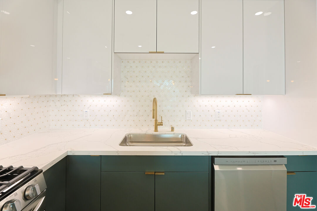 4000 Mont Clair Street, Unit 201 Los Angeles, CA 90018 - Photo 7 of 21 a kitchen with a sink and cabinets
