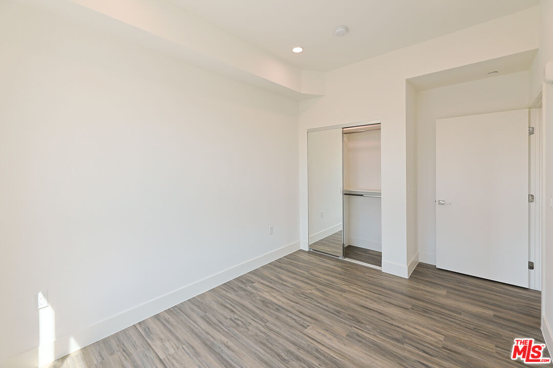 4000 Mont Clair Street, Unit 201 Los Angeles, CA 90018 - Photo 10 of 21 a view of an empty room and wooden floor