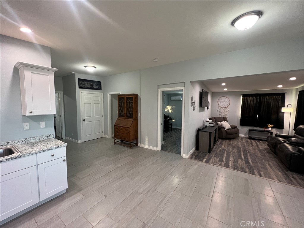 20240 Juniper Road Apple Valley, CA 92308 - Photo 13 of 25 a view of a living room kitchen and a wooden floor
