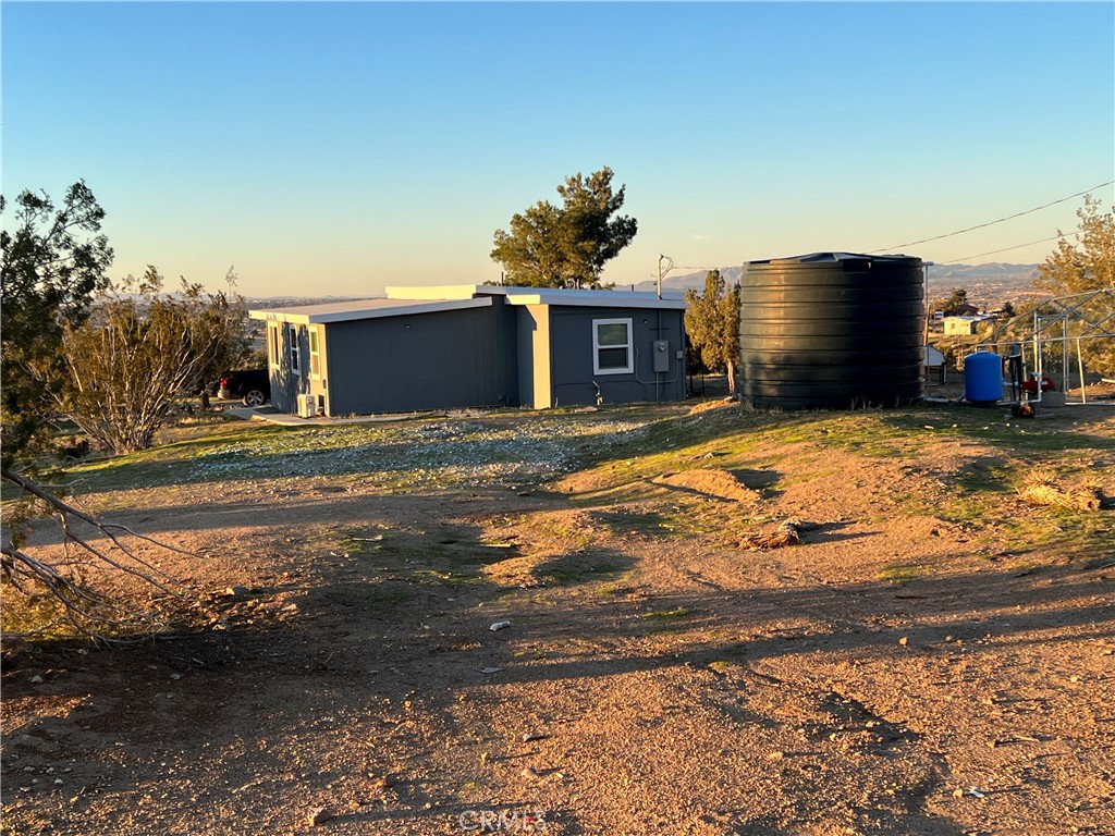 20240 Juniper Road Apple Valley, CA 92308 - Photo 16 of 25 a view of a house with a snow in the yard