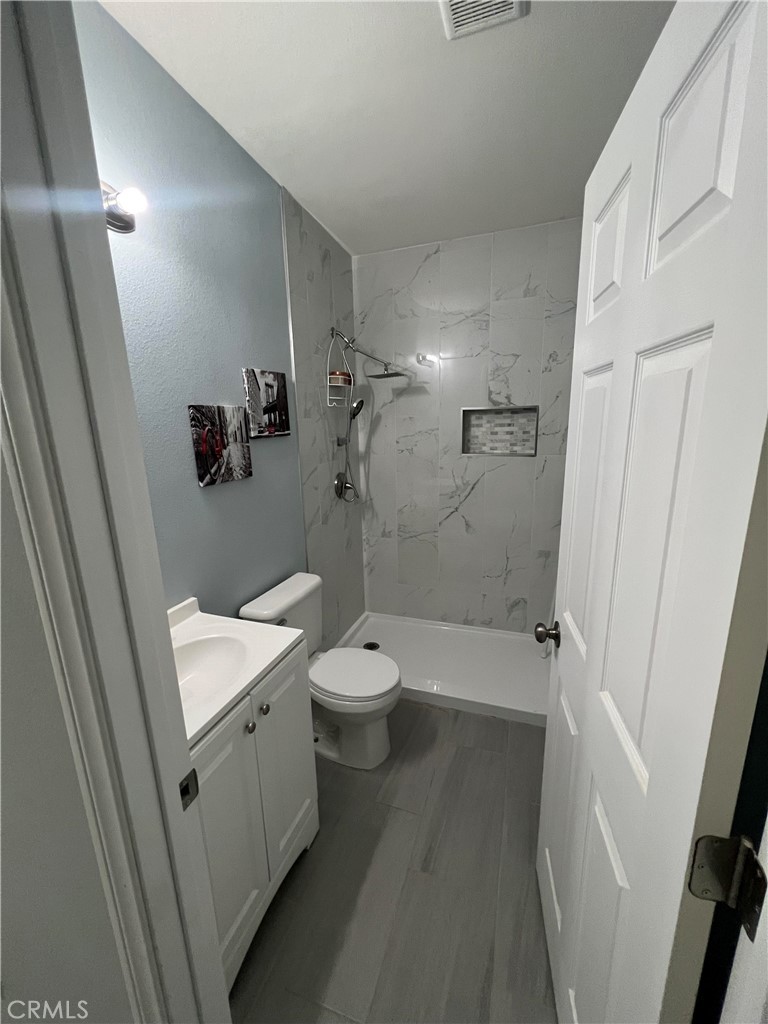 20240 Juniper Road Apple Valley, CA 92308 - Photo 9 of 25 a bathroom with a sink a toilet and shower