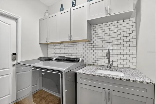 a bedroom with a bed a dresser and wooden floor