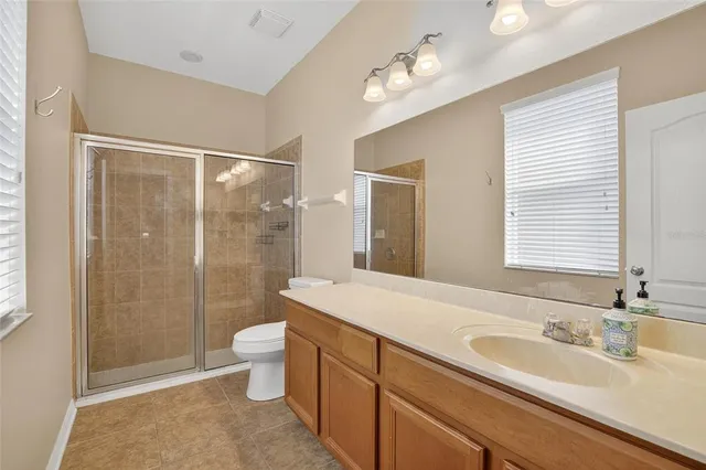 an empty room with a ceiling fan and wooden floor