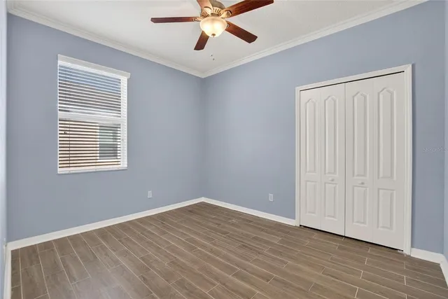 a kitchen with a sink and large windows