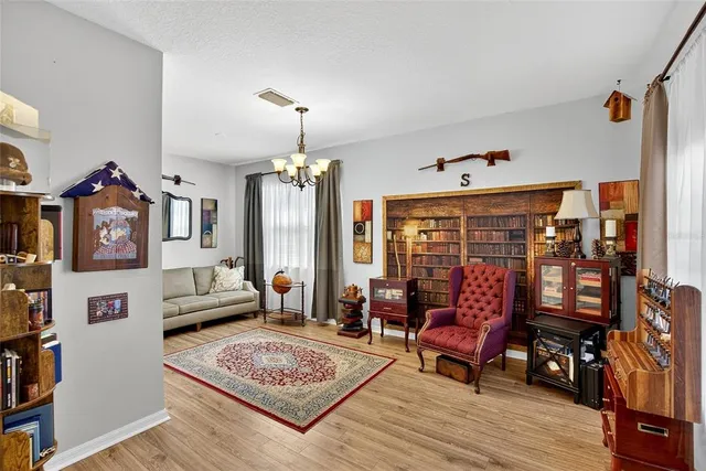 a living room with fireplace furniture and a chandelier