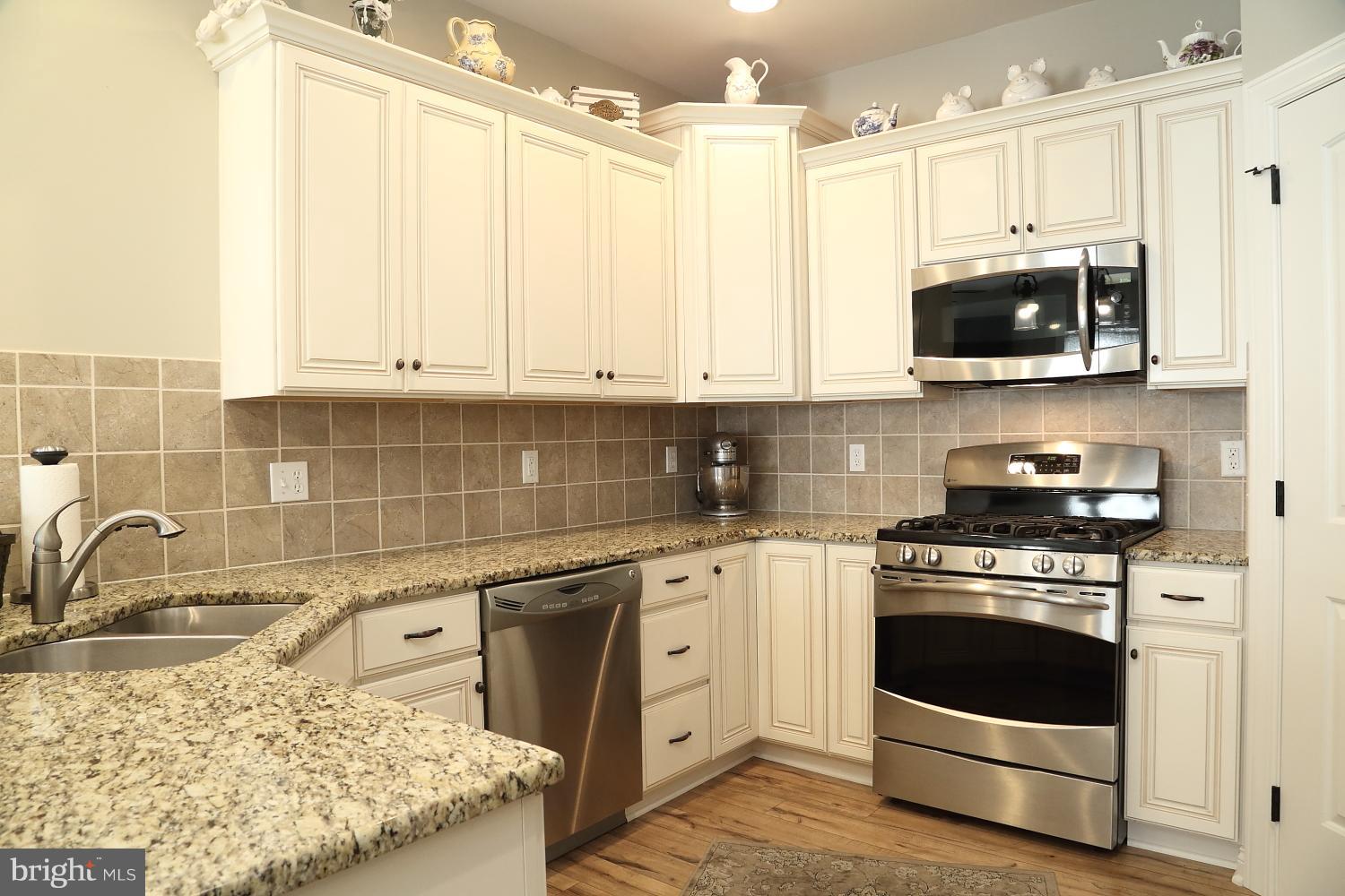 134 River Birch Drive Lititz, PA 17543 - Photo 3 of 27 White kitchen with granite counters and backsplash