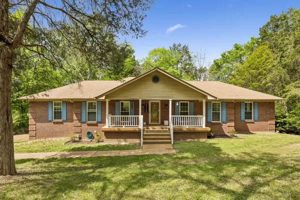 a front view of a house with a yard table and chairs