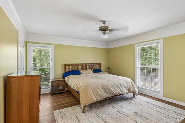 a bedroom with a large bed and a window