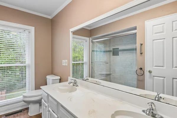 a bathroom with a sink toilet and shower