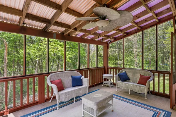 a balcony with furniture and wooden floor